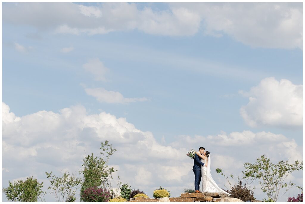 bride and groom photo at retreat 21 on top of waterfall