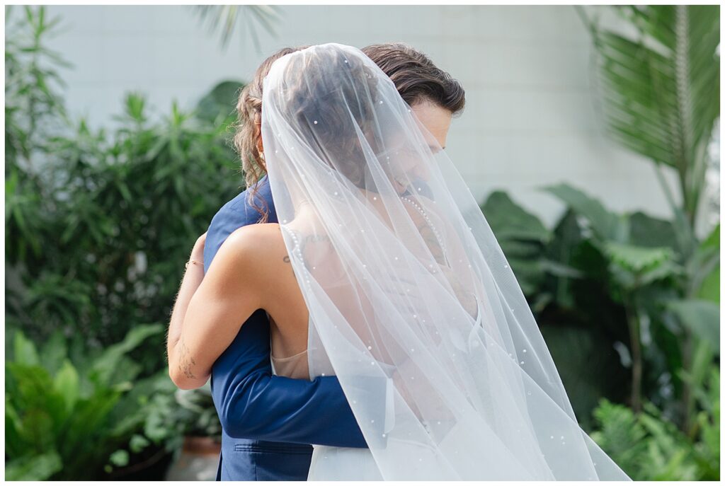 bride and groom hug after their first look