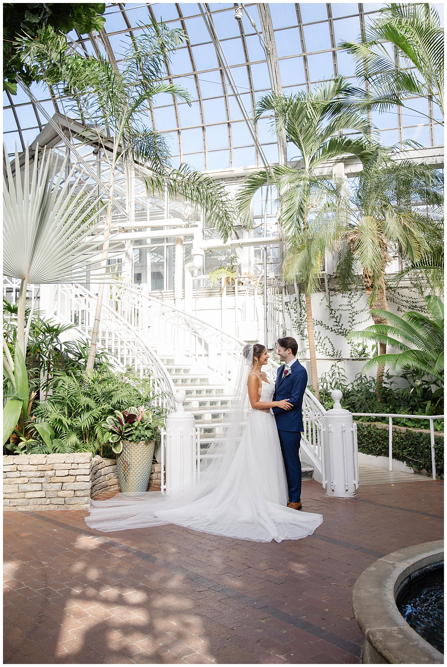 bride and groom on the steps of the Palm House at Franklin Park Conservatory
