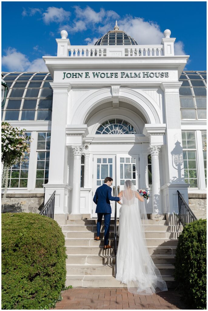 bride and groom walking into the Palm House at Franklin Park Conservatory wedding venuw